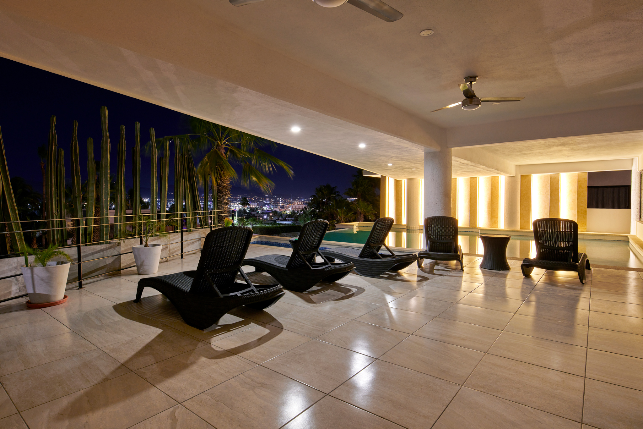 Pedregal Towers pool terrace at night — Cabo San Lucas