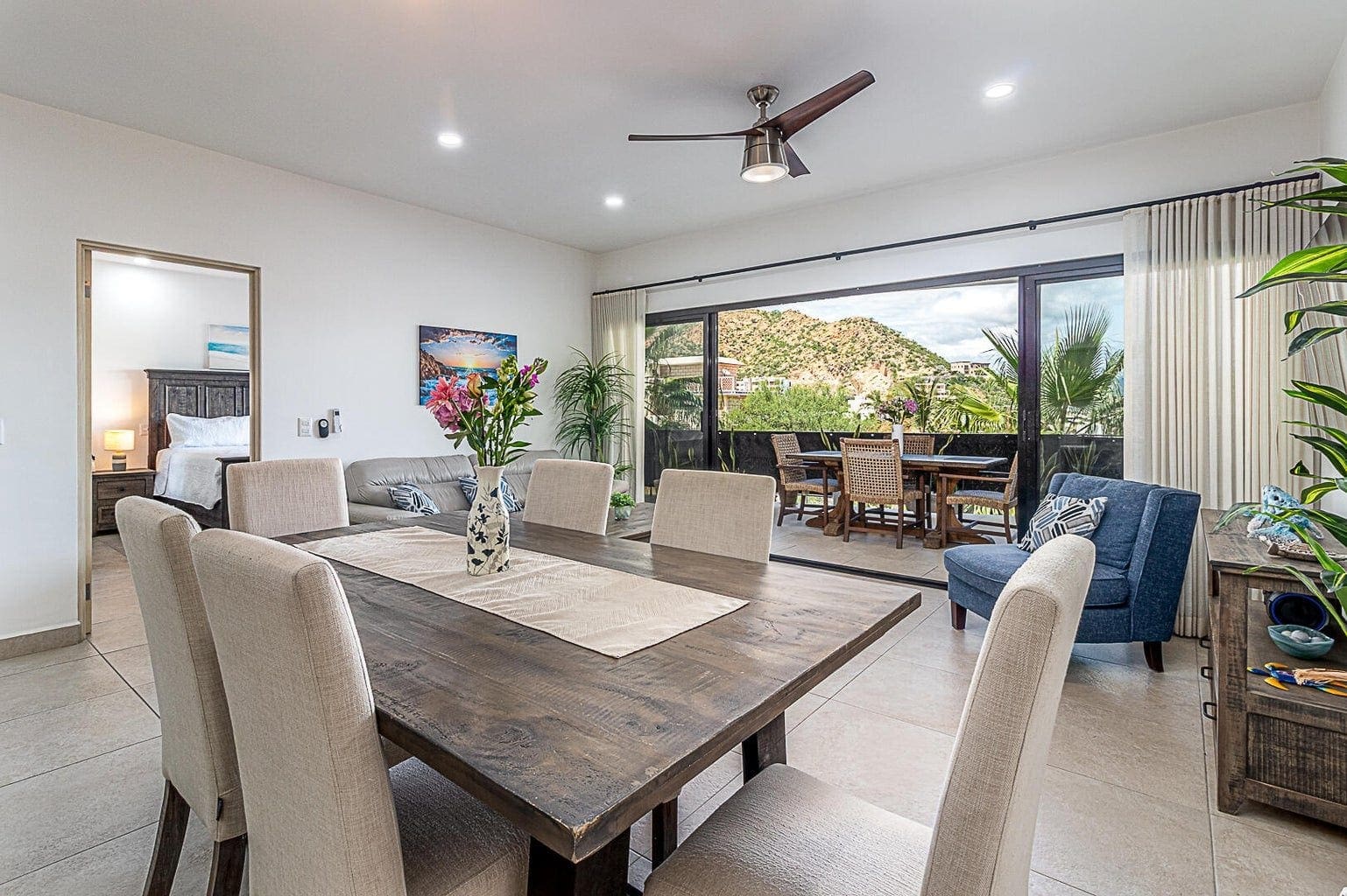 Living and dining area with sliding doors open to the terrace