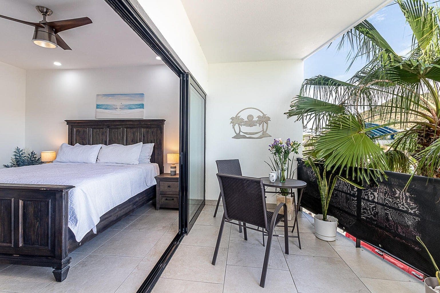 Master bedroom with king bed and sliding doors to private balcony