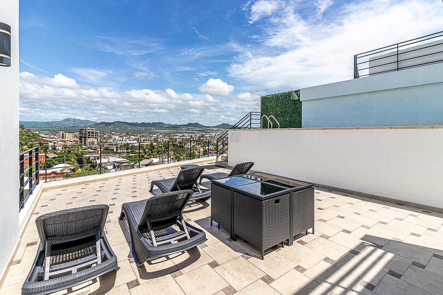 Rooftop sun deck with loungers at Pedregal Towers