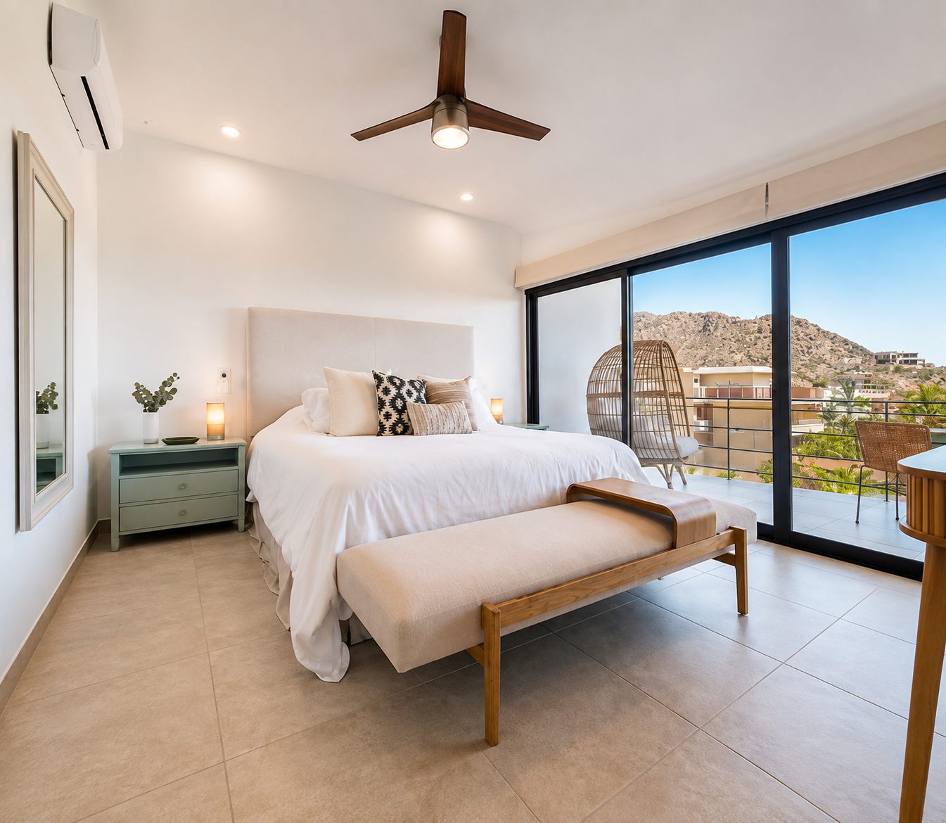 Primary bedroom with king bed and balcony doors