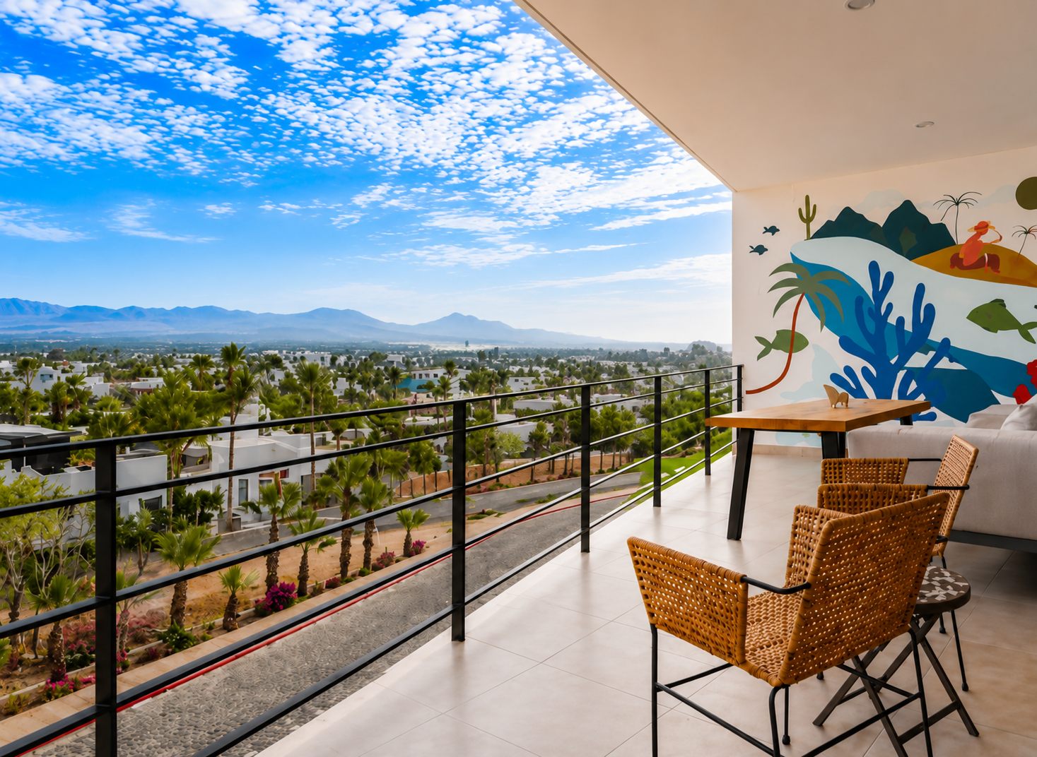 Vista Sierra at Pedregal Towers — covered terrace overlooking rooftops, palms and the mountains