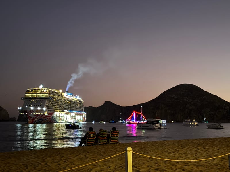 Medano Beach at night with pirate ship cruise — a common evening scene near our Cabo Airbnb